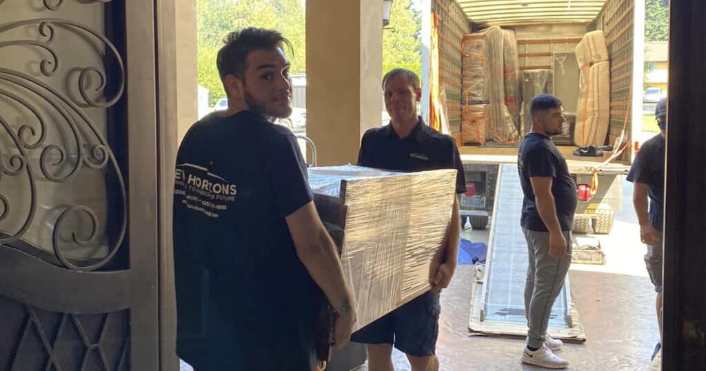 federal way movers moving table from truck to home