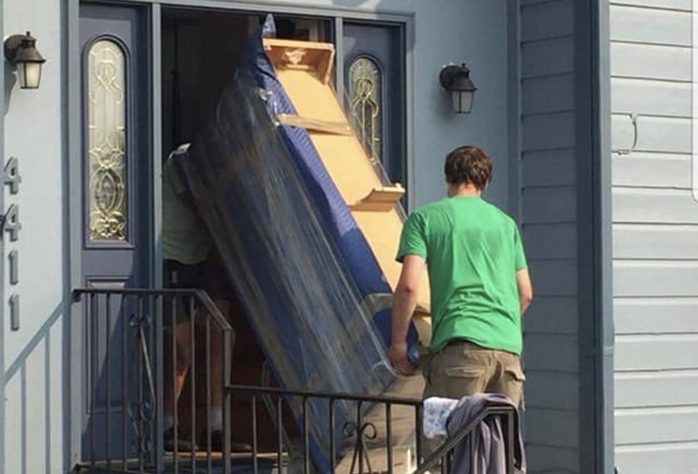 movers moving a large piece of furniture