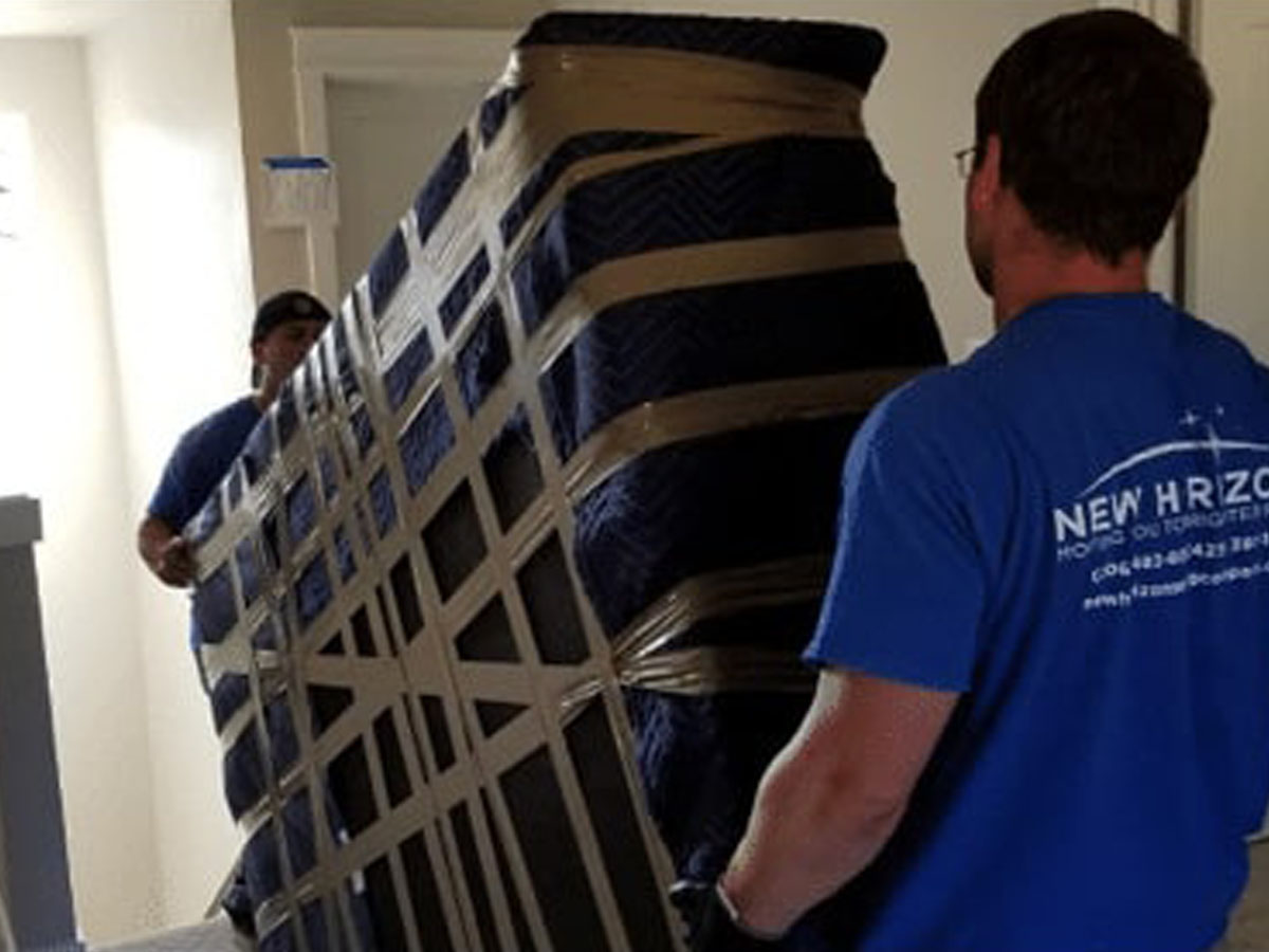 movers moving a large piece of furniture